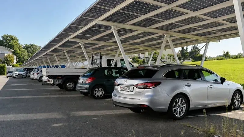 Commercial solar carport structure over a large parking lot with PV modules