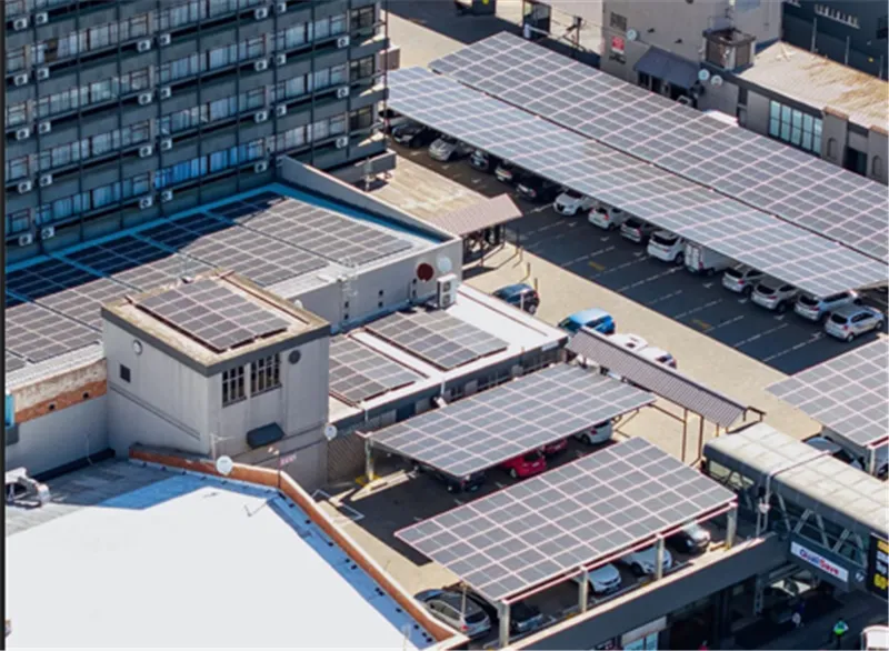 Solar carport with electric vehicle charging stations in a parking area