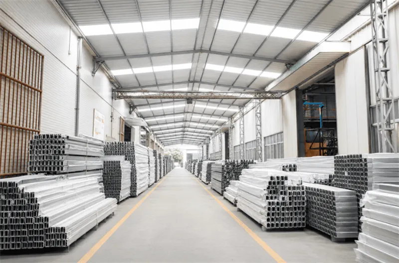 Easy Solar factory warehouse with packed aluminum rails, clamps, pallets, export cartons and quality inspection stock