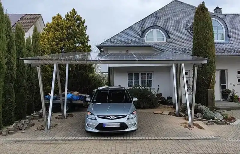 Home solar carport structure with PV modules above a residential parking space
