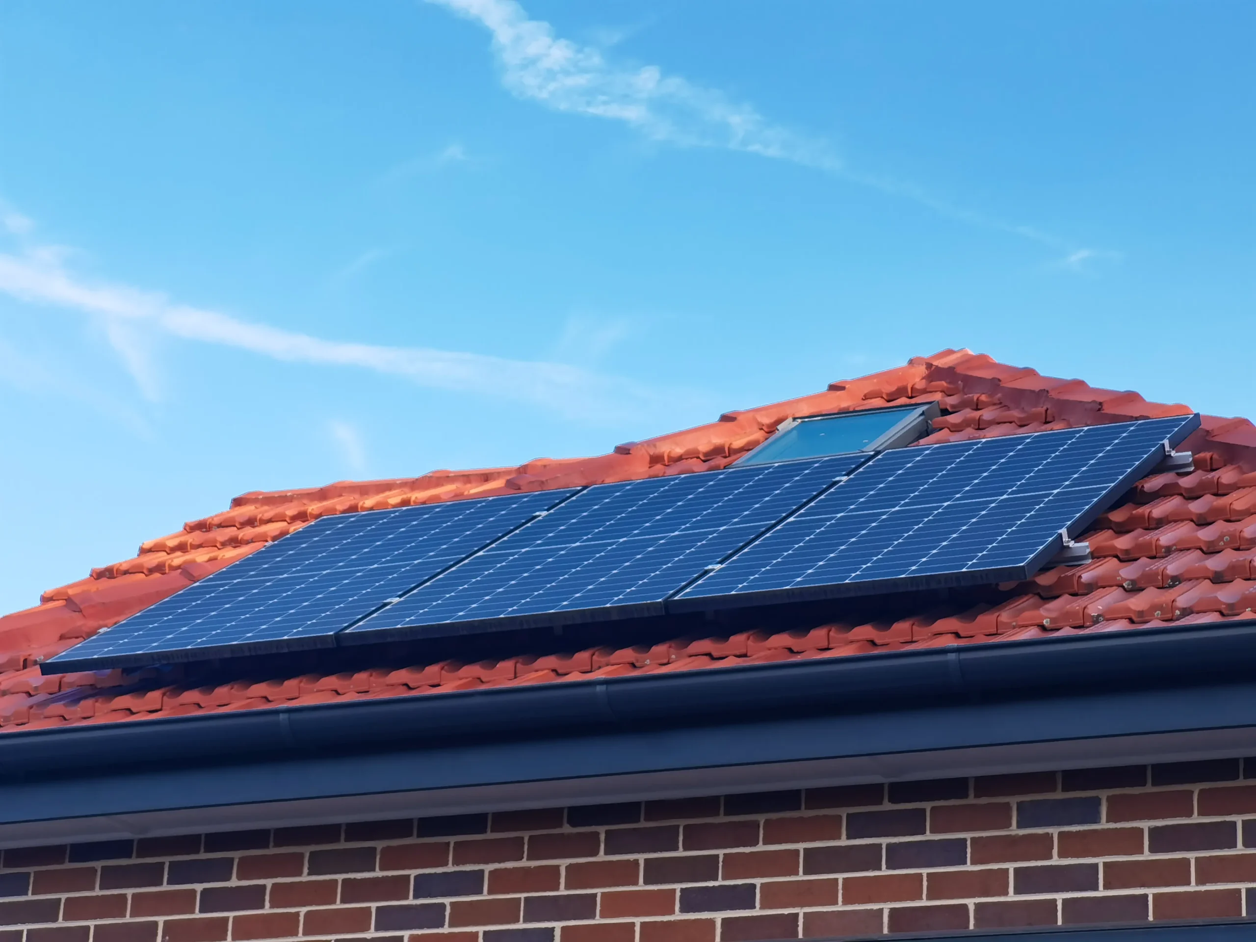 Installer reviewing residential roof conditions and solar mounting components